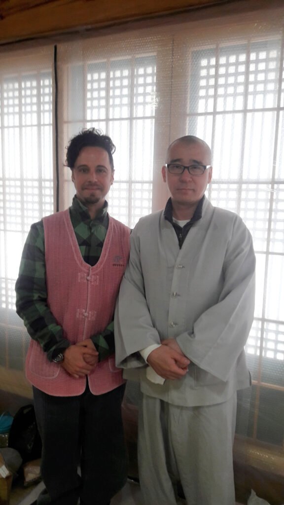 JP Morselli (left) standing next to a monk (right)