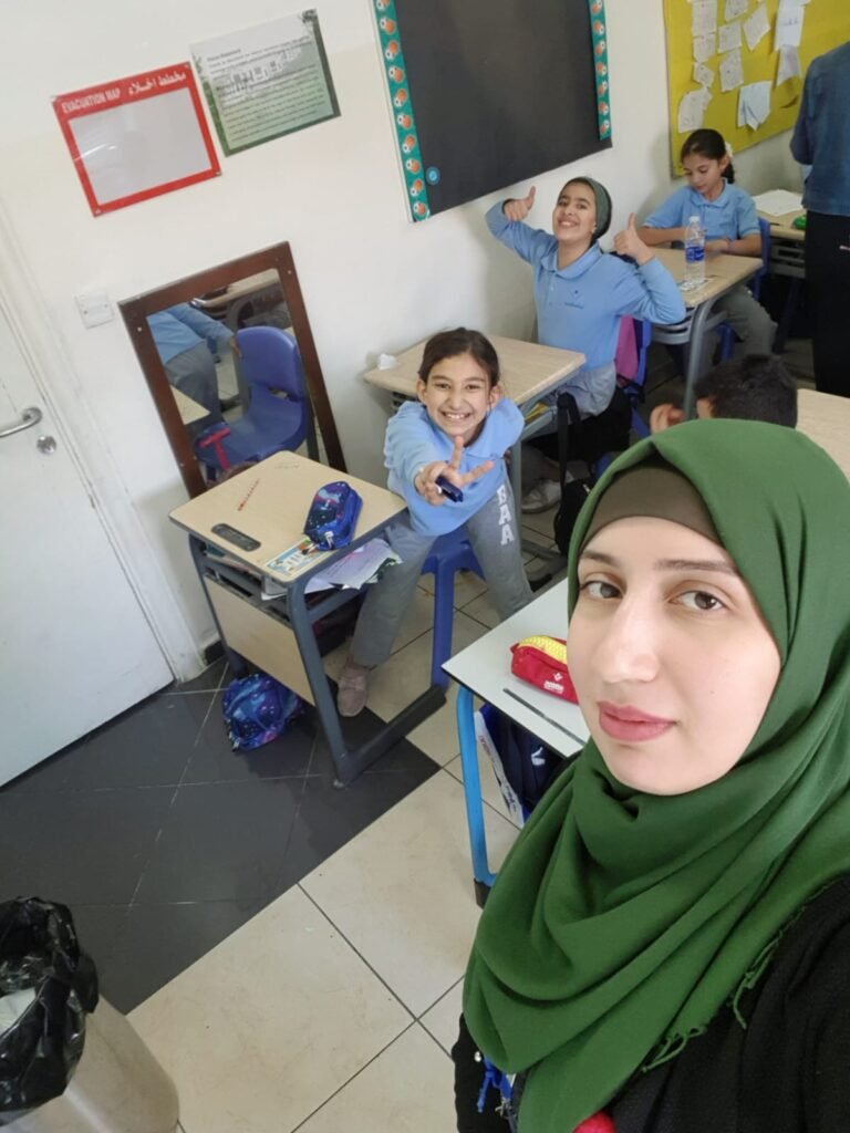 Wiam Najjar selfie shot with a few students in a classroom