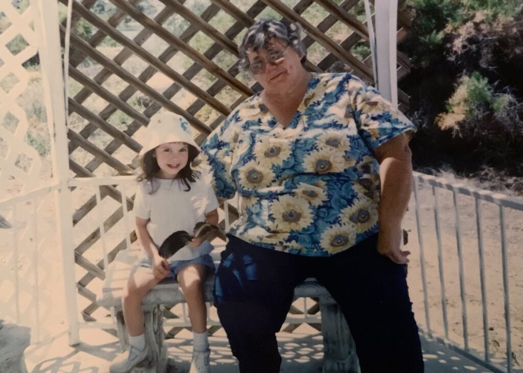 Brooklyn as a young child sitting next to their grandma.