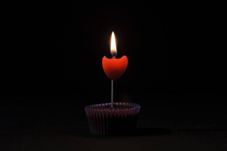 Image of solo candle burning in the dark