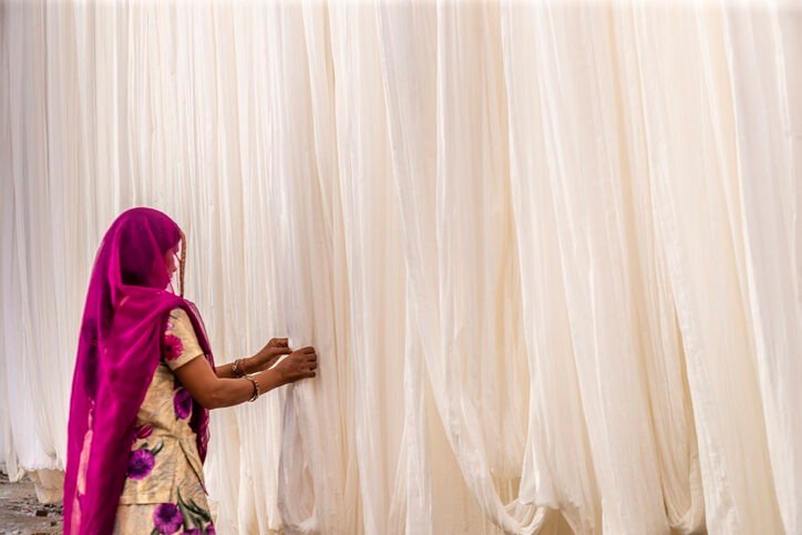 Indian woman about to open curtain