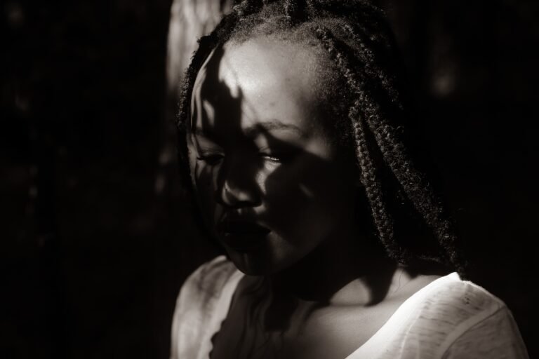 Black woman's face covered by shadows