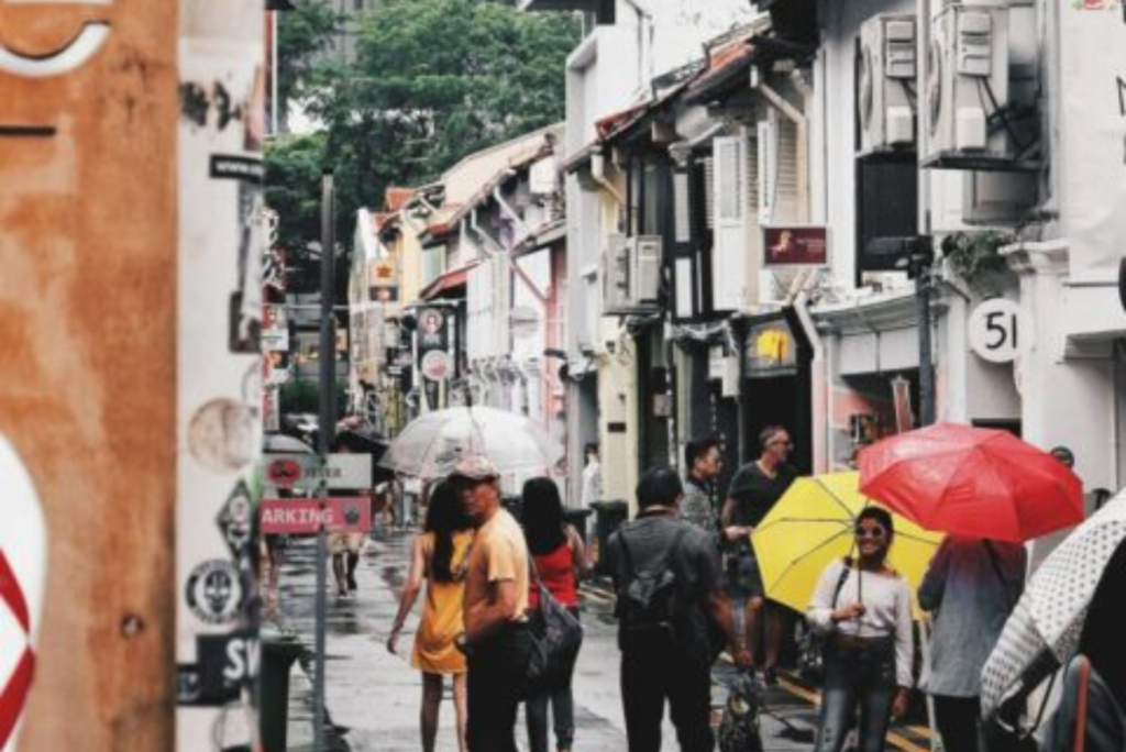 City shot of Vietnam with people walking holding umbrellas