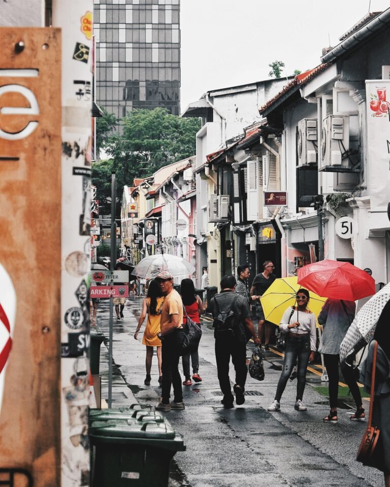 City shot of Vietnam with people walking holding umbrellas