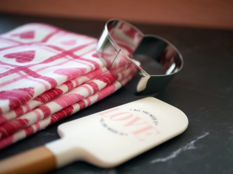 baking utensils next to a towel with heart designs on it
