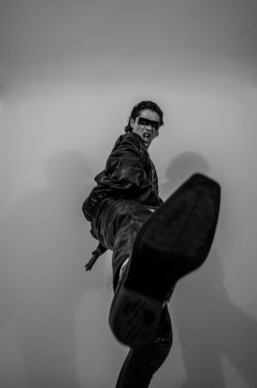 Man stamping his foot at the camera
