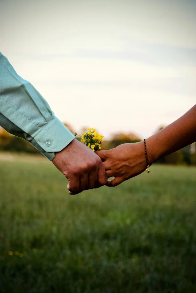 Lovers holding a flower.